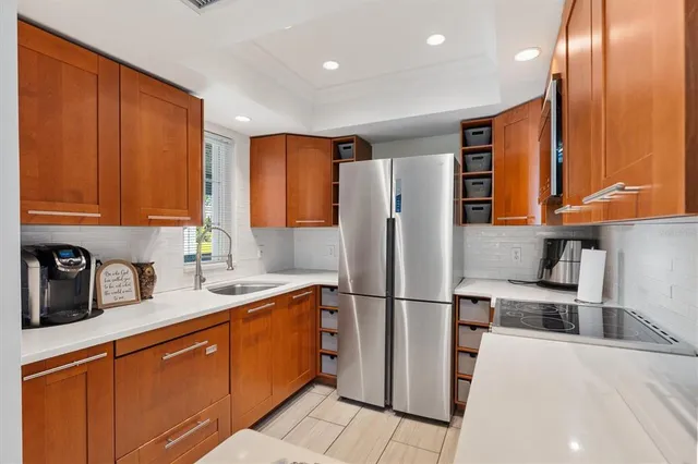 a kitchen with a stove and a flat screen tv