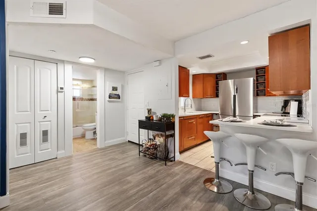 a living room with furniture flat screen tv and wooden floor