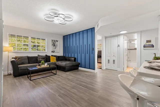 a living room with furniture and wooden floor