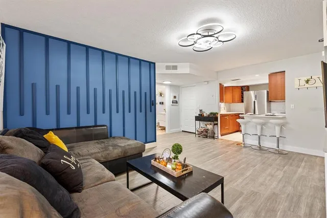 a kitchen with stainless steel appliances granite countertop a refrigerator stove microwave and cabinets