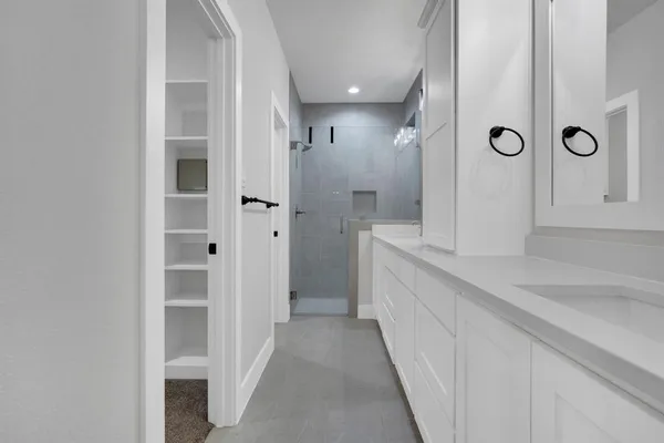 a bathroom with a double vanity sink and a mirror