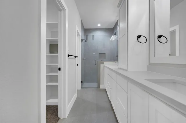 a bathroom with a double vanity sink and a mirror