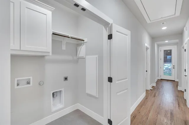 a view of a hallway with wooden floor and closet