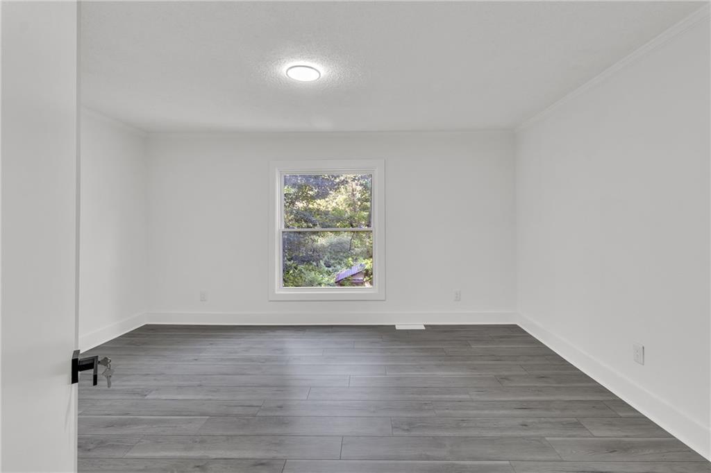 5483 Wylstream Way Norcross, GA 30093 - Photo 11 of 56 an empty room with wooden floor and window