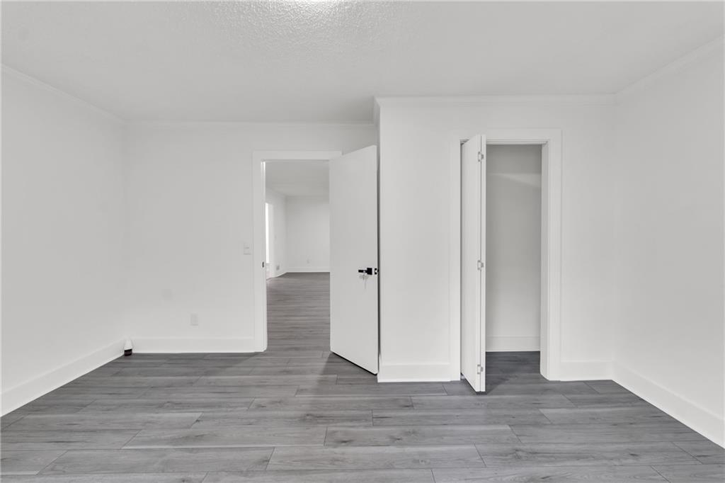 5483 Wylstream Way Norcross, GA 30093 - Photo 12 of 56 a view of an empty room and wooden floor