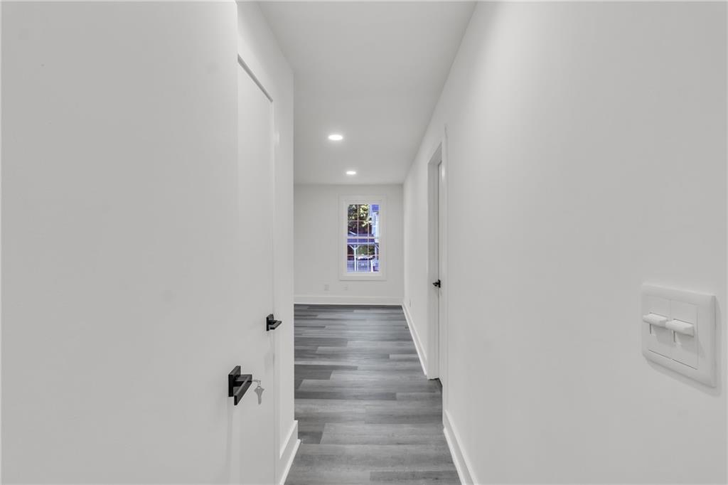 5483 Wylstream Way Norcross, GA 30093 - Photo 14 of 56 a view of a hallway with wooden floor and entryway