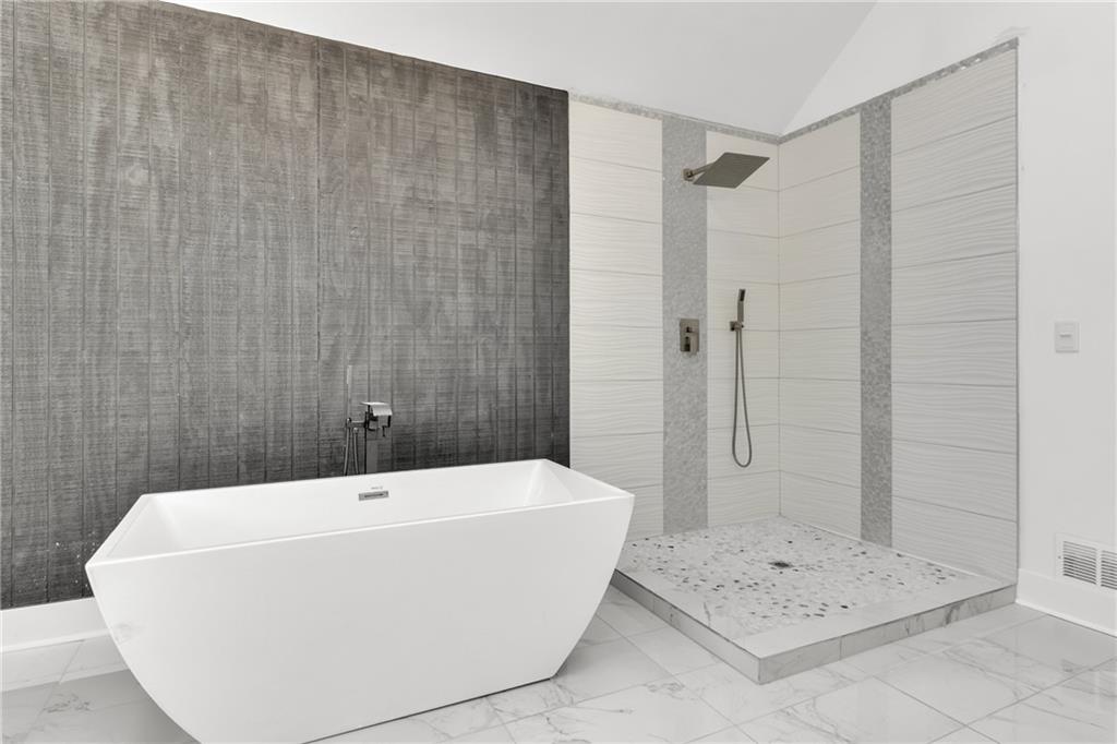 5483 Wylstream Way Norcross, GA 30093 - Photo 19 of 56 a bathroom with a bathtub and shower