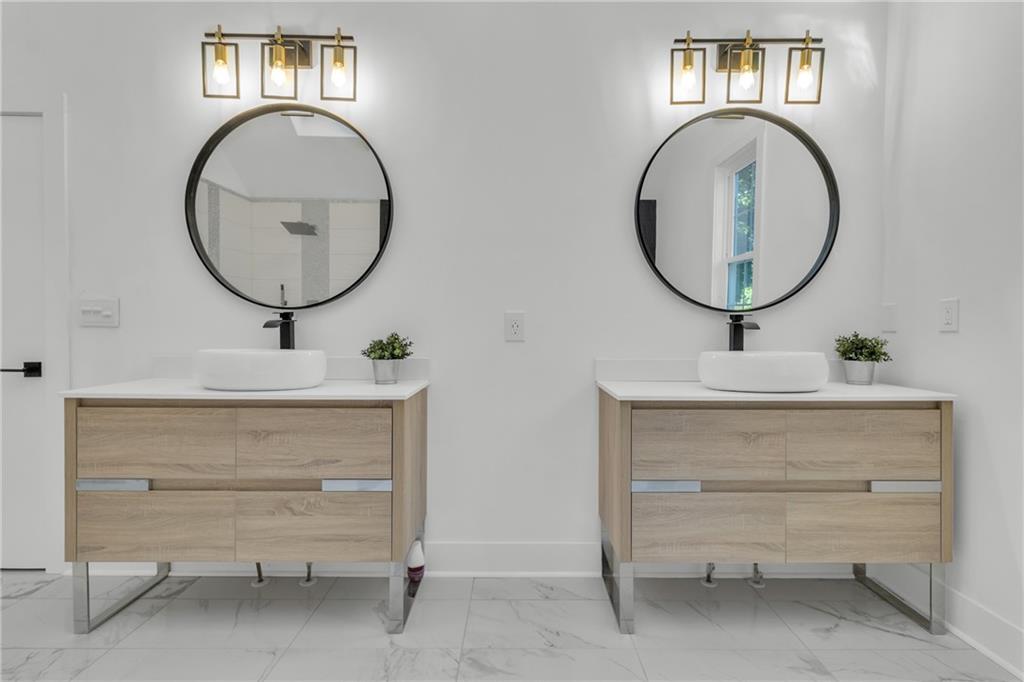 5483 Wylstream Way Norcross, GA 30093 - Photo 20 of 56 a bathroom with a sink and a mirror