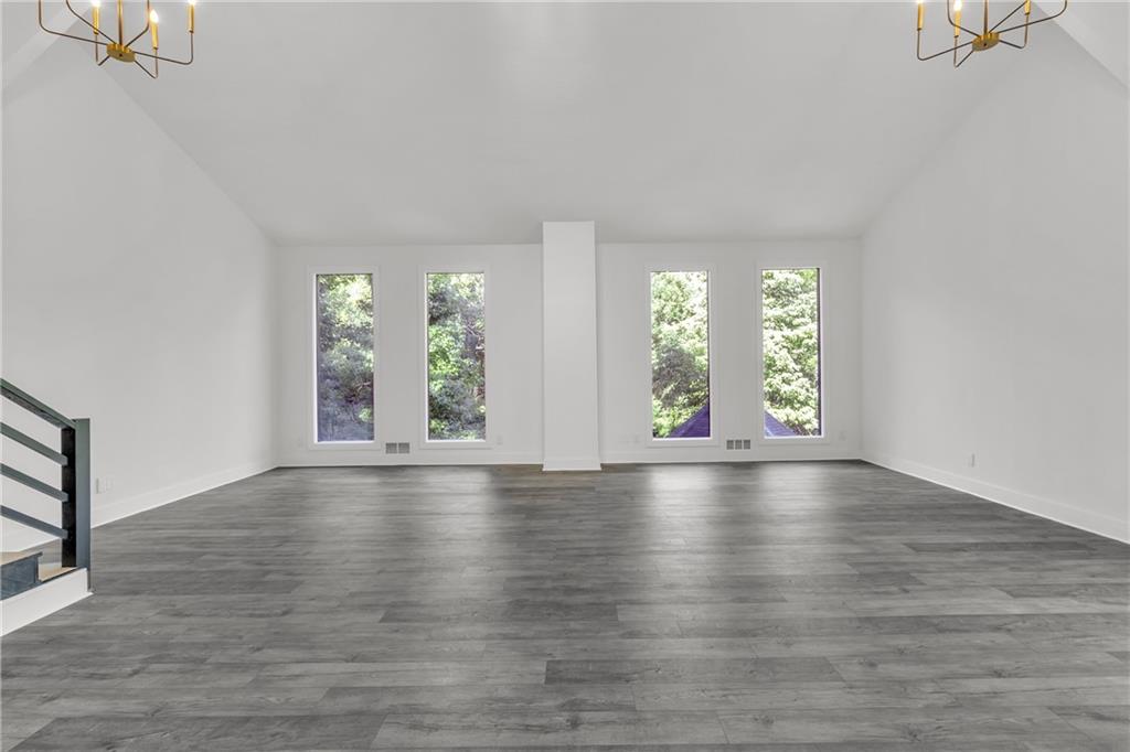 5483 Wylstream Way Norcross, GA 30093 - Photo 21 of 56 an empty room with wooden floor and windows