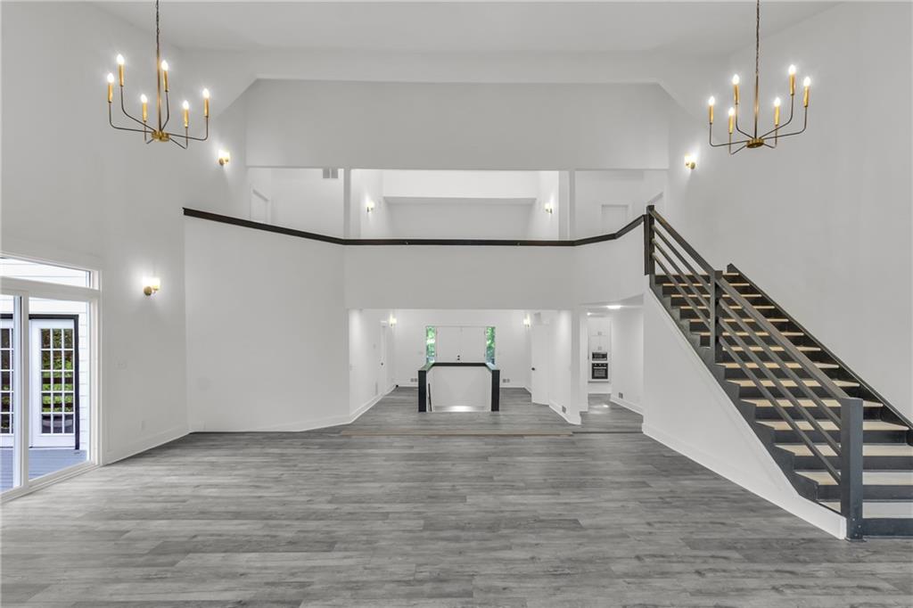 5483 Wylstream Way Norcross, GA 30093 - Photo 22 of 56 a view of a hallway with wooden floor and staircase