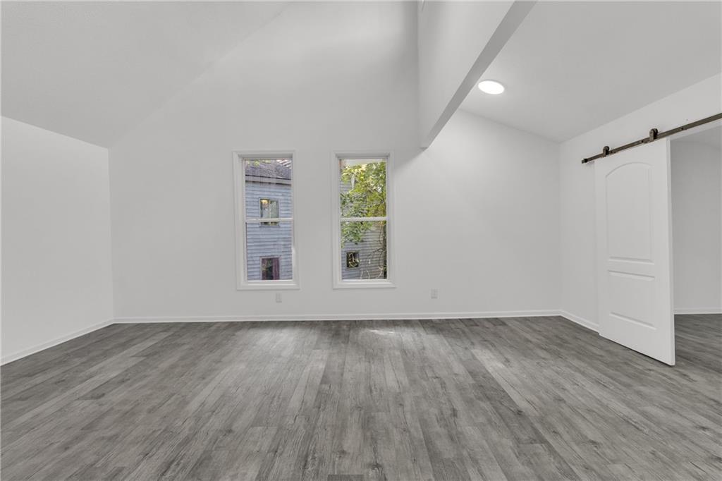 5483 Wylstream Way Norcross, GA 30093 - Photo 23 of 56 an empty room with wooden floor and windows