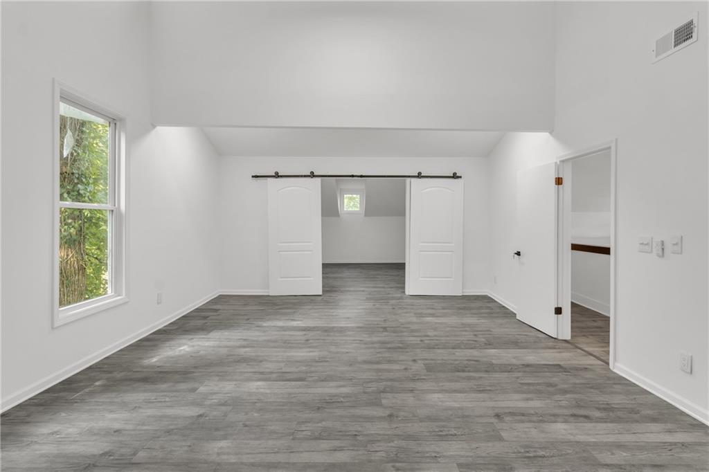 5483 Wylstream Way Norcross, GA 30093 - Photo 24 of 56 wooden floor in an empty room with a window