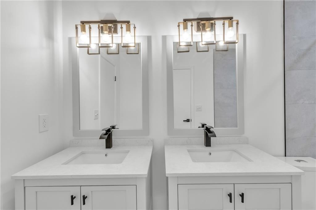 5483 Wylstream Way Norcross, GA 30093 - Photo 26 of 56 a bathroom with double sink and a mirror