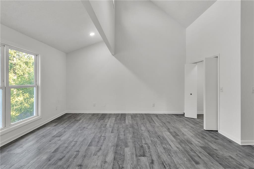 5483 Wylstream Way Norcross, GA 30093 - Photo 28 of 56 an empty room with wooden floor and windows