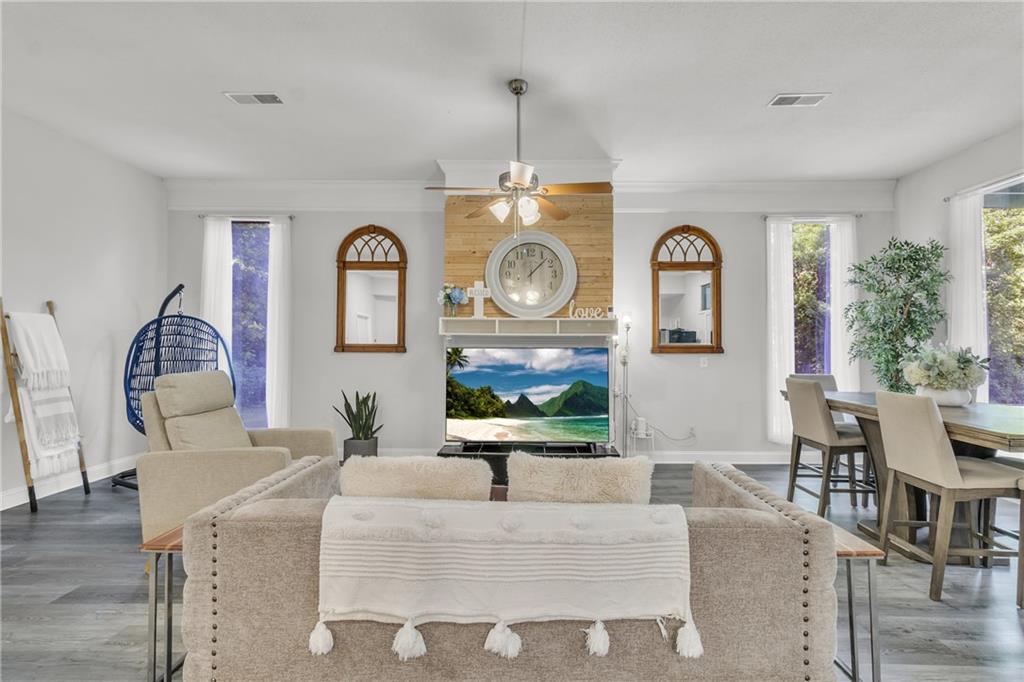 5483 Wylstream Way Norcross, GA 30093 - Photo 34 of 56 a living room with furniture a clock and a window