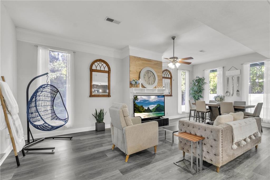 5483 Wylstream Way Norcross, GA 30093 - Photo 35 of 56 a living room with furniture a fireplace and a window