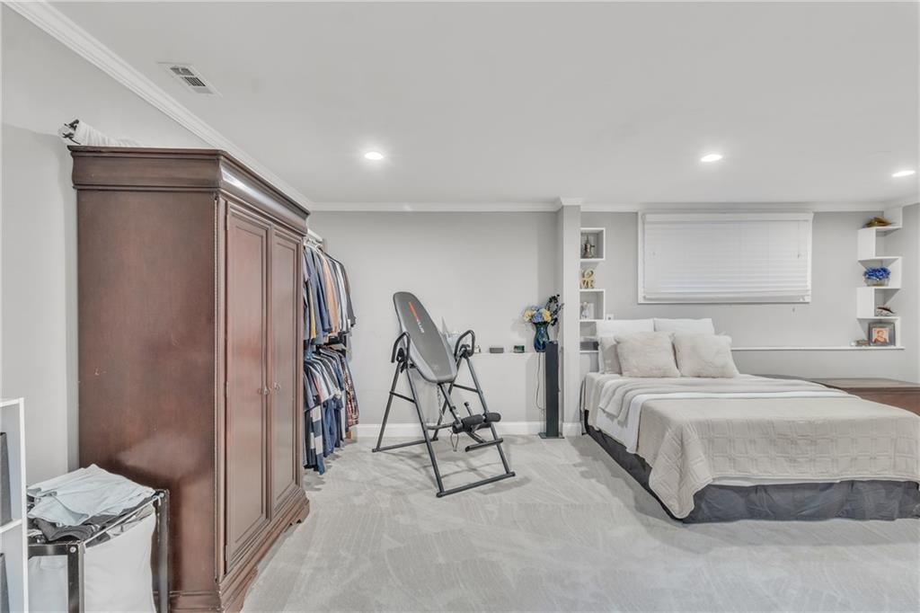 5483 Wylstream Way Norcross, GA 30093 - Photo 40 of 56 a spacious bedroom with a bed and a table