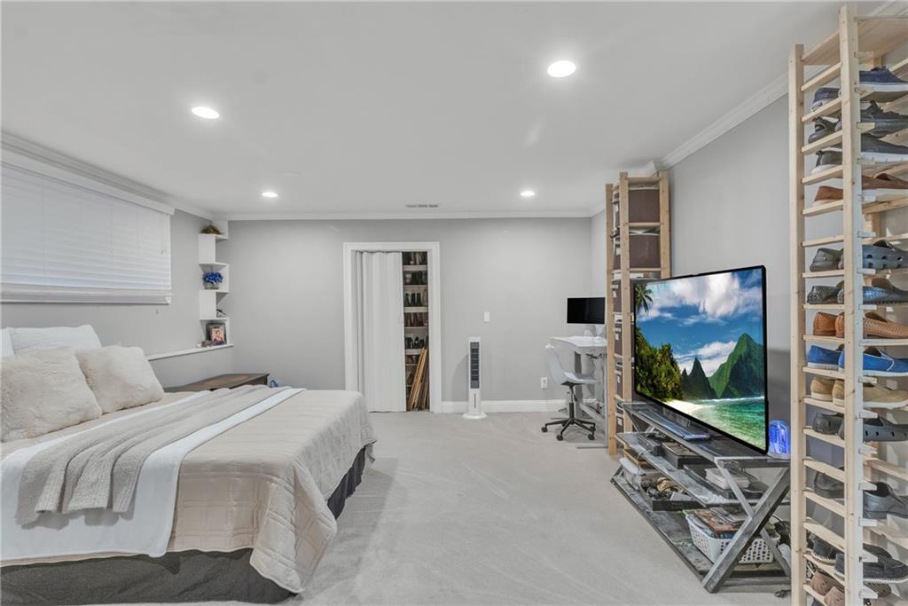 5483 Wylstream Way Norcross, GA 30093 - Photo 41 of 56 a bedroom with a bed and a flat screen tv