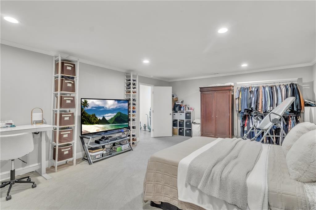 5483 Wylstream Way Norcross, GA 30093 - Photo 43 of 56 a bedroom with a bed and a flat screen tv