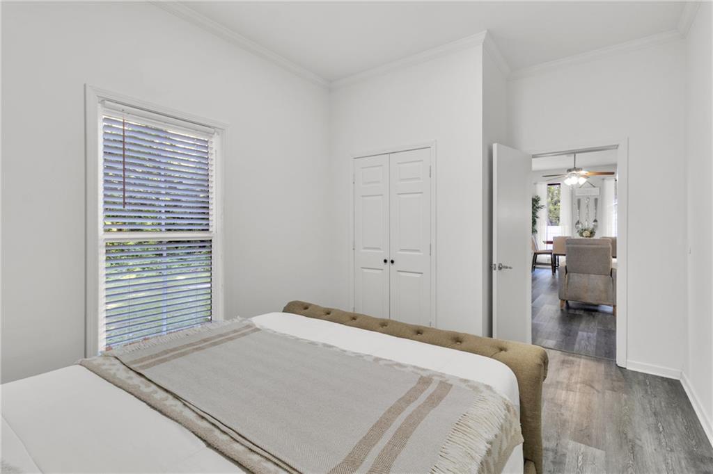 5483 Wylstream Way Norcross, GA 30093 - Photo 45 of 56 a bedroom with a bed and a chandelier