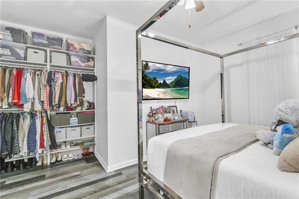 5483 Wylstream Way Norcross, GA 30093 - Photo 47 of 56 a bedroom with furniture and a flat screen tv