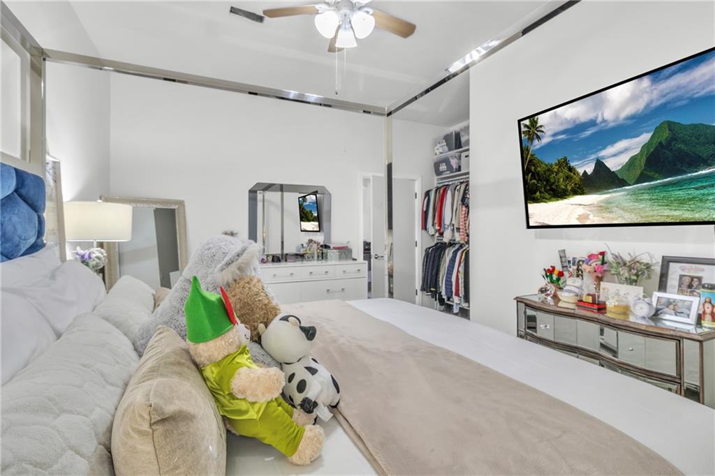 5483 Wylstream Way Norcross, GA 30093 - Photo 48 of 56 a living room with furniture a flat screen tv and a floor to ceiling window