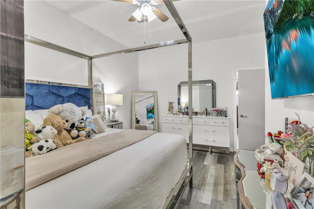 5483 Wylstream Way Norcross, GA 30093 - Photo 49 of 56 a bedroom with a large bed and a chandelier