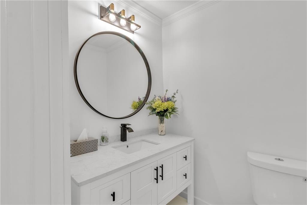 5483 Wylstream Way Norcross, GA 30093 - Photo 8 of 56 a bathroom with a sink and a mirror