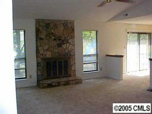 6832 Pence Road Charlotte, NC 28227 - Photo 4 of 8 an empty room with windows and fireplace
