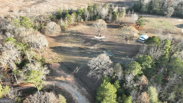 a view of a yard with wooden fence