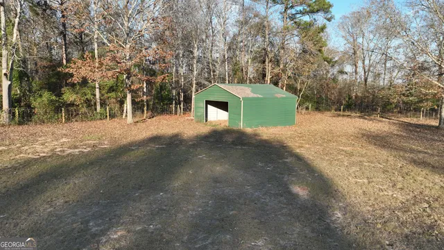 a view of backyard with large trees