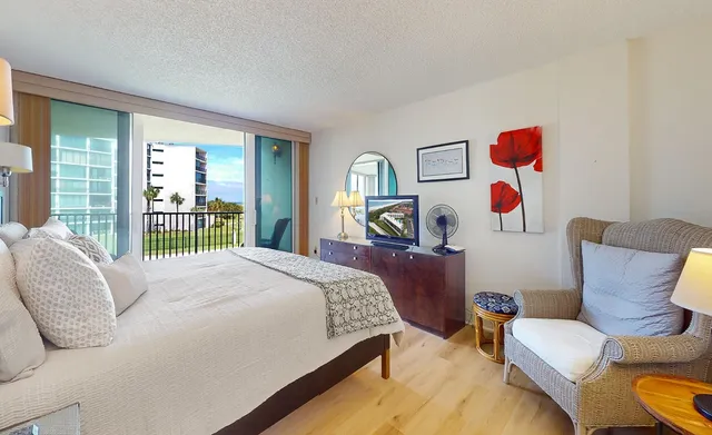 a bedroom with a bed and a large window