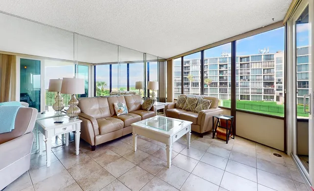 a living room with furniture and a floor to ceiling window