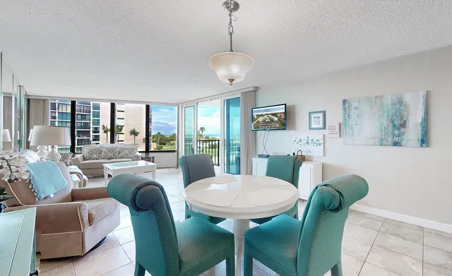 a view of a dining room with furniture window and wooden floor