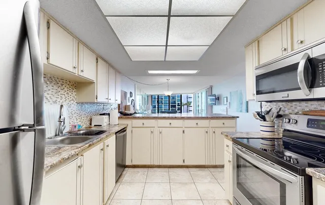 a kitchen with granite countertop a stove sink and cabinets