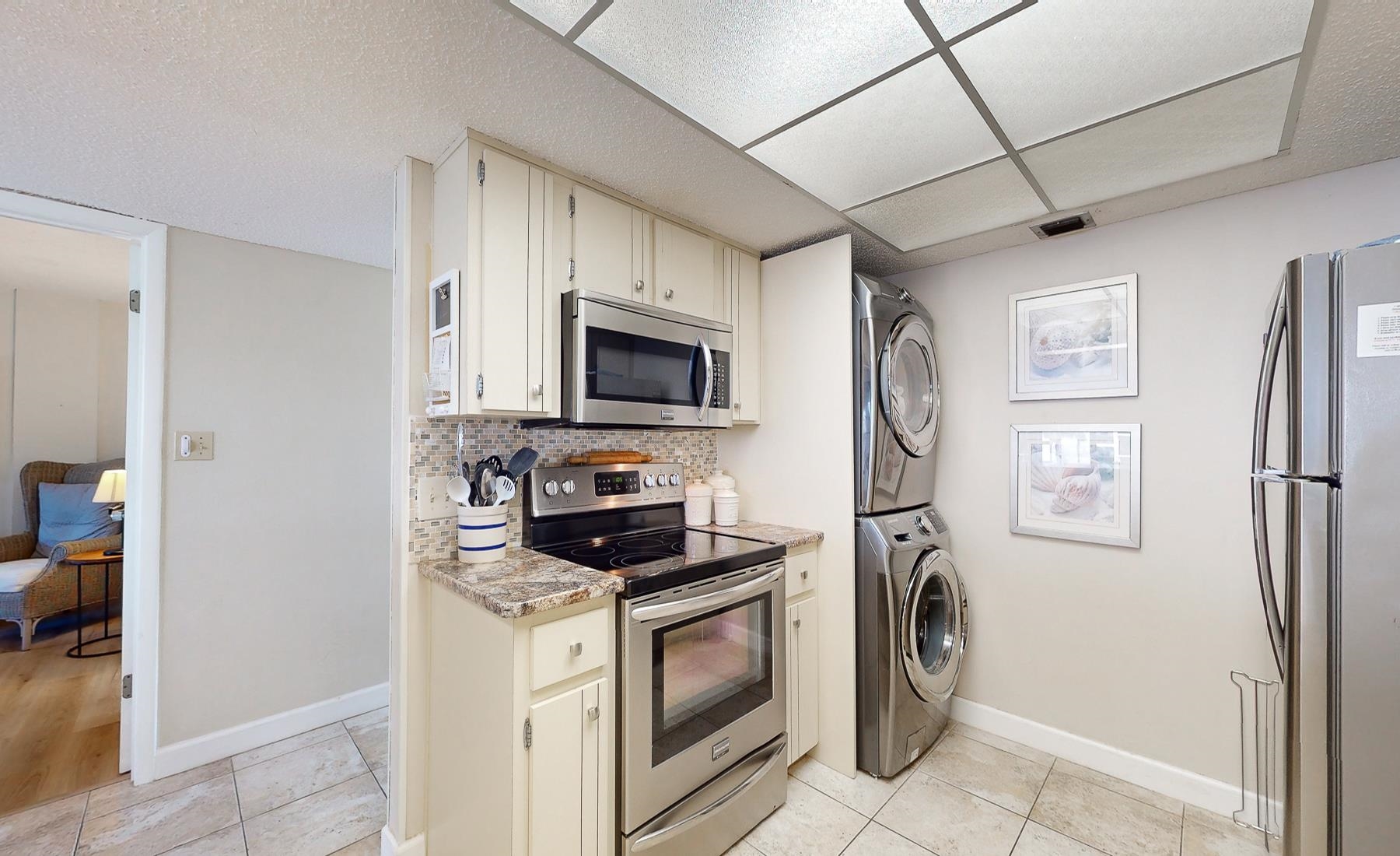 1 Dondanville Road, Unit C 215 St. Augustine, FL 32080 - Photo 10 of 33 a kitchen with stainless steel appliances granite countertop a refrigerator a stove top oven a sink and dishwasher