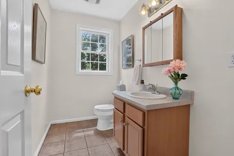 a bathroom with a sink toilet and mirror