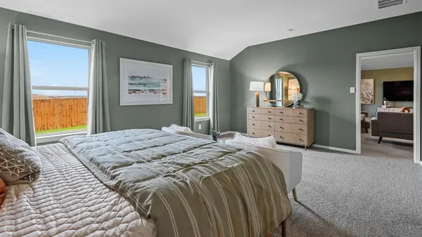 a bedroom with a bed a lamp and window