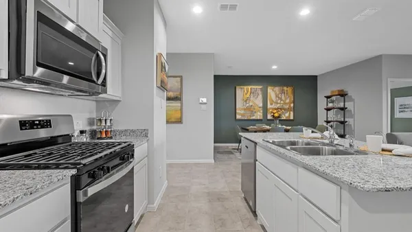 a stove top oven sitting inside of a kitchen