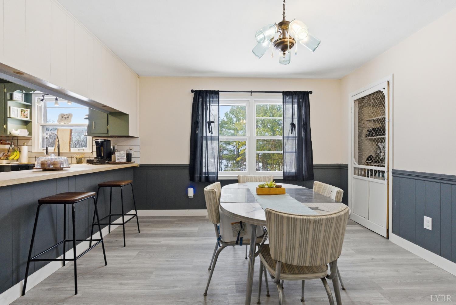 5225 Blue Ridge Drive Gretna, VA 24557 - Photo 9 of 28 a kitchen with a dining table chairs and chandelier