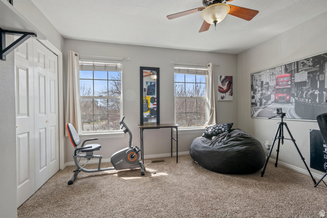 962 Independence Avenue Provo, UT 84604 - Photo 15 of 31 Exercise room featuring carpet flooring, healthy amount of natural light, and ceiling fan