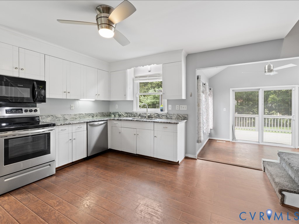 12230 Harrowgate Road Chester, VA 23831 - Photo 9 of 38 Kitchen featuring white cabinetry, stone counterto