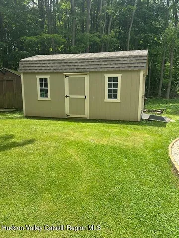 a dining room with wooden floor a chandelier a wooden table and chairs