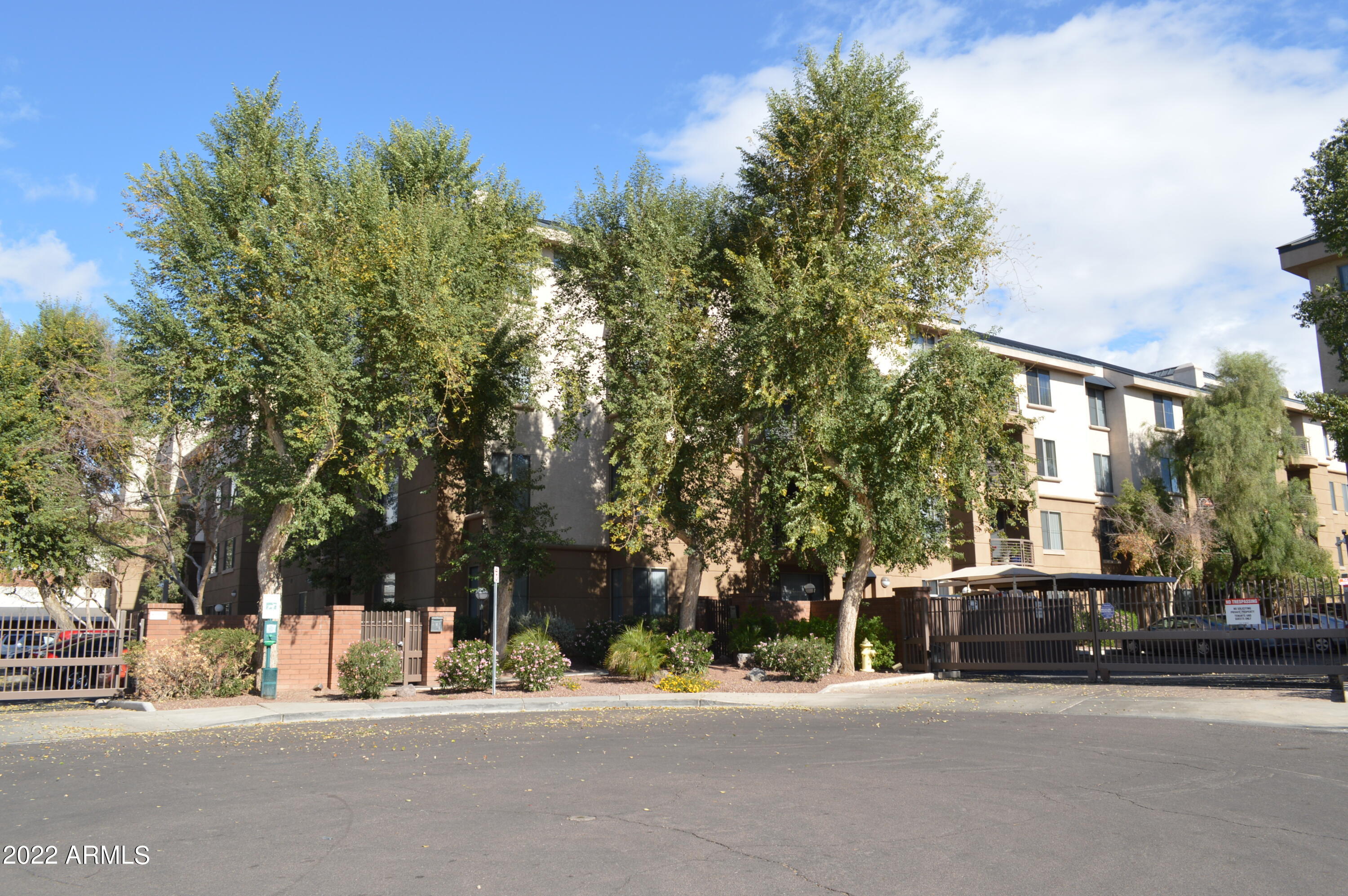 1701 East Colter Street, Unit 459 Phoenix, AZ 85016 - Photo 44 of 50 a building exterior with tall trees