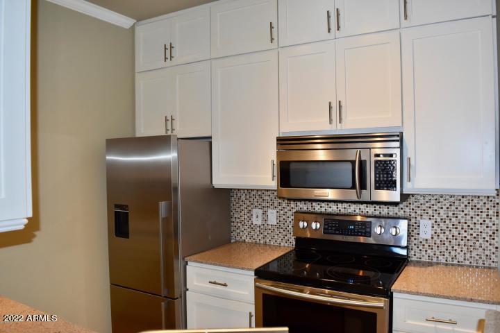 1701 East Colter Street, Unit 459 Phoenix, AZ 85016 - Photo 6 of 50 a kitchen with a stove and a microwave