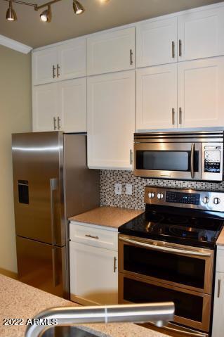 1701 East Colter Street, Unit 459 Phoenix, AZ 85016 - Photo 7 of 50 a stove top oven sitting inside of a kitchen