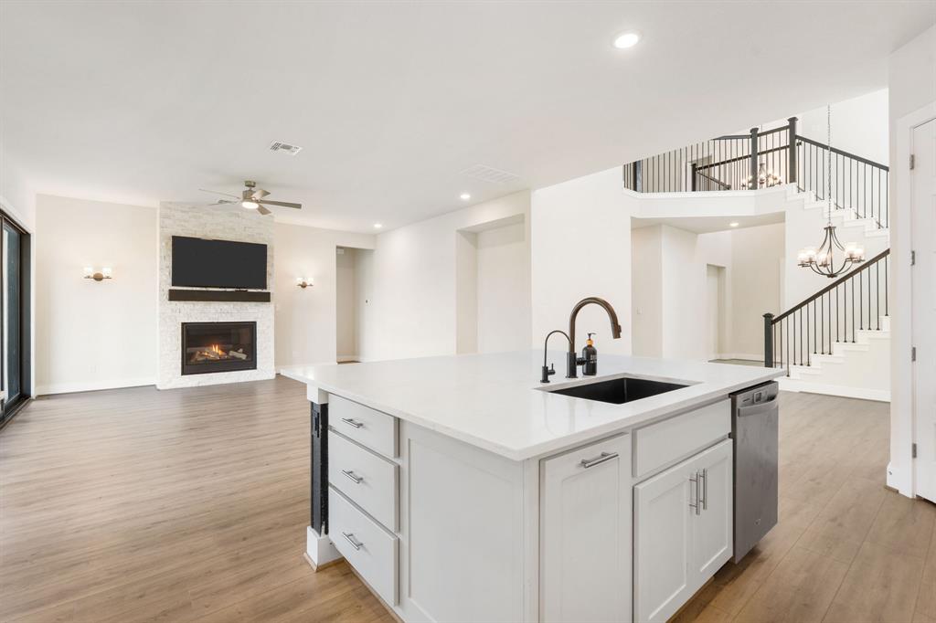 504 Tomichi Trail Austin, TX 78738 - Photo 36 of 36 a kitchen with a sink and a stove top oven with wooden floor