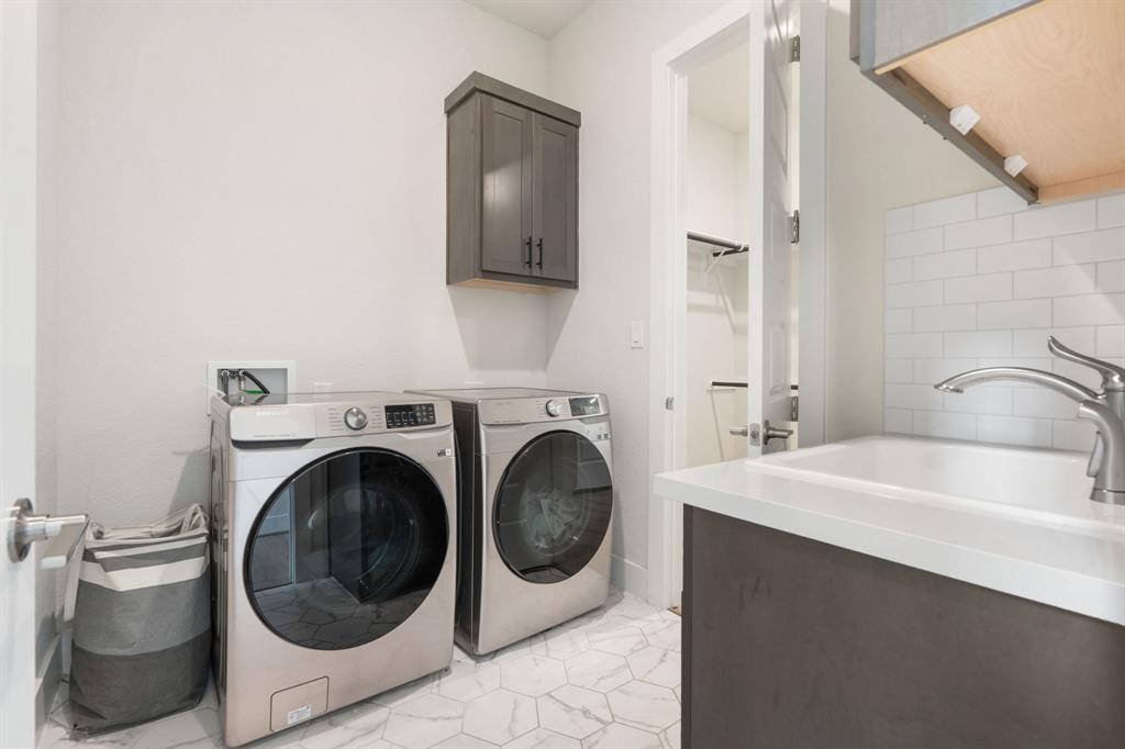 504 Tomichi Trail Austin, TX 78738 - Photo 21 of 36 a bathroom with a sink a washer and dryer