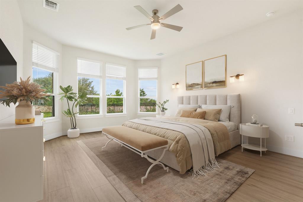 504 Tomichi Trail Austin, TX 78738 - Photo 22 of 36 a bedroom with a large bed and a large window