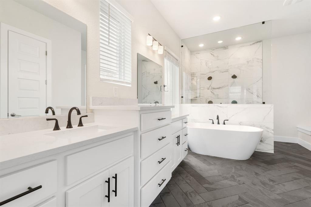 504 Tomichi Trail Austin, TX 78738 - Photo 24 of 36 a bathroom with a bathtub sink double vanity and mirror